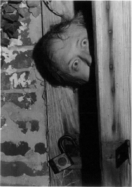 Photo of John Gilmer coming out of smokehouse, Woodbourne